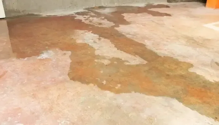 Wet patches across an exposed concrete floor