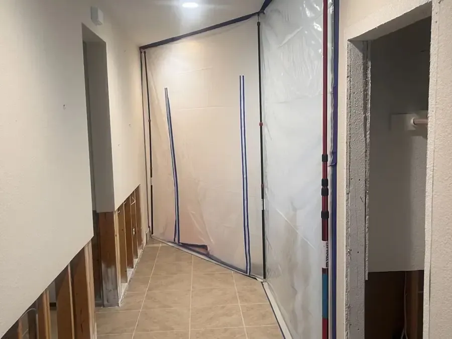 Lower wall cavities opened along an interior hallway