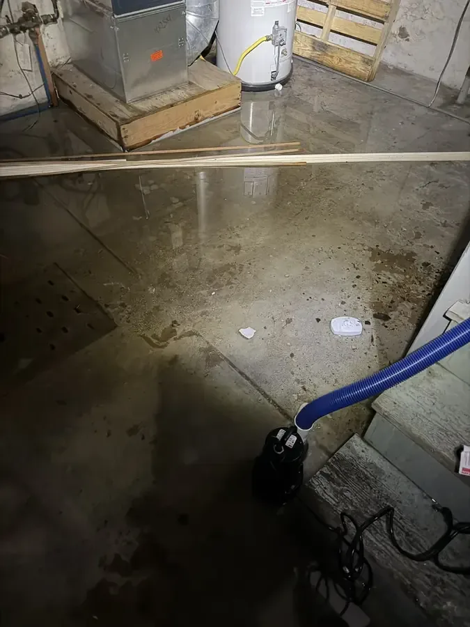 Water removal hose crossing a wet utility-room floor