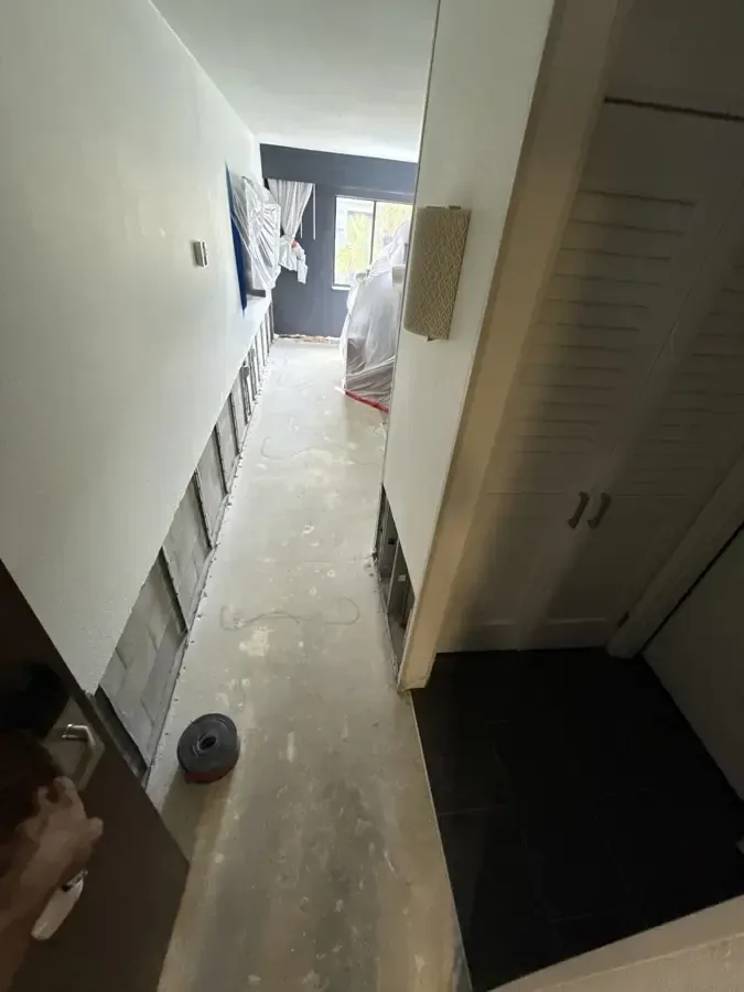 Opened floor and wall edges in a narrow interior hallway